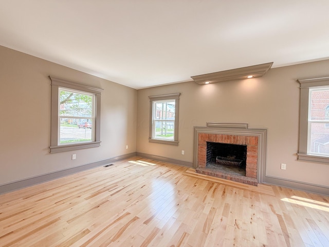 69 N Cherry St, Mount Gilead, OH 43338 - unfurnished living room featuring wood finished floors, healthy amount of natural light, and a fireplace