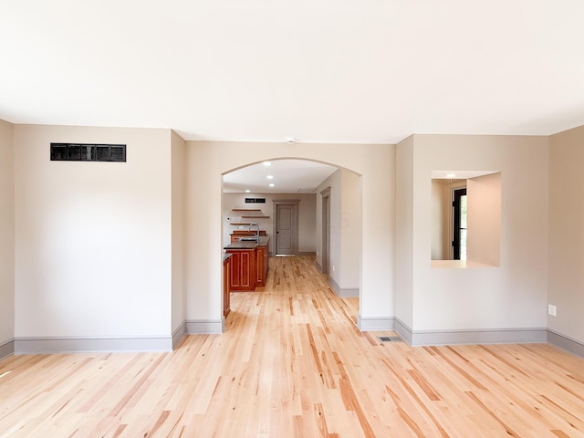 69 N Cherry St, Mount Gilead, OH 43338 - corridor featuring arched walkways and light wood-style floors