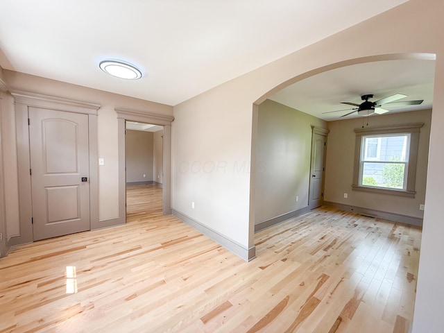 69 N Cherry St, Mount Gilead, OH 43338 - spare room with arched walkways, light wood finished floors, and a ceiling fan