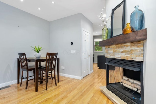 979 Delaware Ave, Columbus, OH 43201 - dining room with light wood-type flooring, recessed lighting, and a stone fireplace