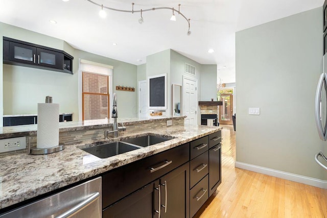 979 Delaware Ave, Columbus, OH 43201 - kitchen featuring light wood-style flooring, dishwasher, light stone counters, and recessed lighting