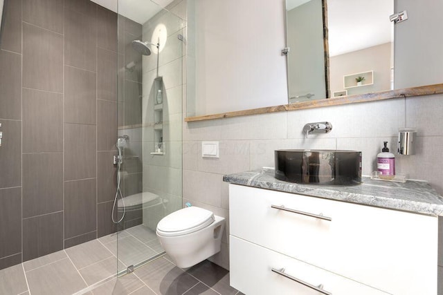 979 Delaware Ave, Columbus, OH 43201 - full bathroom featuring tile walls, walk in shower, vanity, and tile patterned flooring