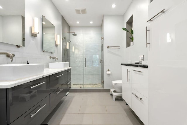 979 Delaware Ave, Columbus, OH 43201 - full bath featuring double vanity, a stall shower, tile patterned floors, and recessed lighting