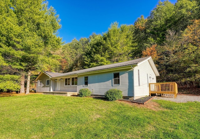 368 Mingo Rd, Chillicothe, OH 45601 - view of front of house with a front lawn, a wooden deck, and a metal roof