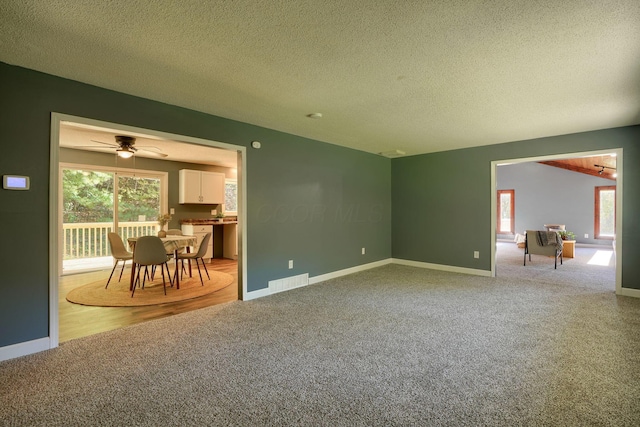 368 Mingo Rd, Chillicothe, OH 45601 - unfurnished living room featuring carpet flooring, a textured ceiling, and ceiling fan