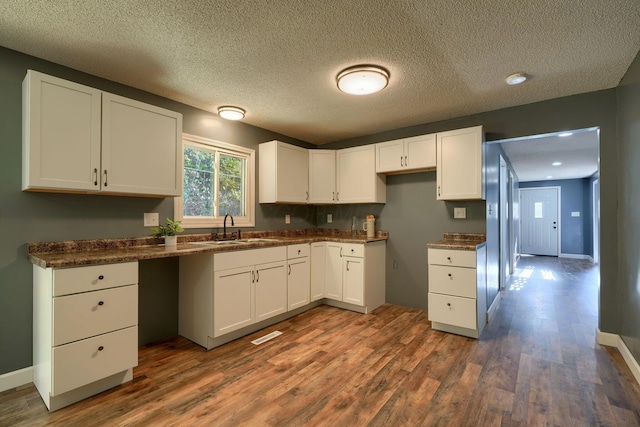 368 Mingo Rd, Chillicothe, OH 45601 - kitchen with dark wood-style floors, white cabinetry, dark countertops, a textured ceiling, and recessed lighting