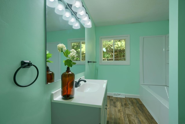 368 Mingo Rd, Chillicothe, OH 45601 - bathroom with vanity, wood finished floors, and a tub to relax in