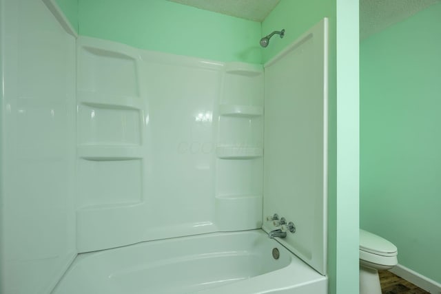 368 Mingo Rd, Chillicothe, OH 45601 - bathroom featuring shower / bathtub combination, a textured ceiling, and wood finished floors