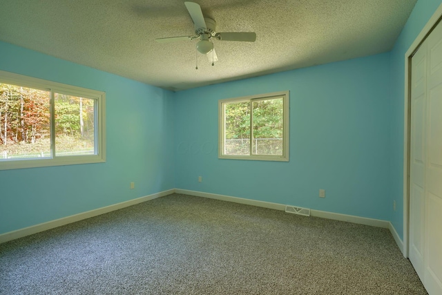 368 Mingo Rd, Chillicothe, OH 45601 - unfurnished bedroom with carpet floors, a textured ceiling, a closet, and a ceiling fan
