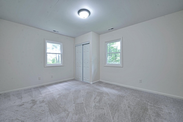 1142 Rozelle Creek Rd, Chillicothe, OH 45601 - unfurnished bedroom featuring multiple windows, carpet floors, and a closet