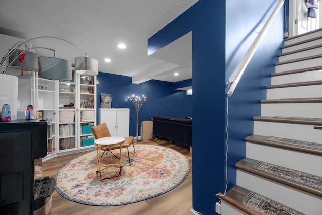 3823 Ramblehurst Rd, Columbus, OH 43221 - sitting room with wood finished floors, stairs, and recessed lighting
