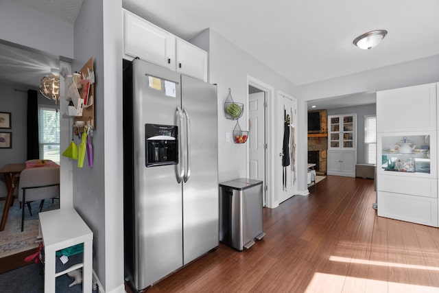 3823 Ramblehurst Rd, Columbus, OH 43221 - kitchen with stainless steel fridge, wood finished floors, white cabinetry, and plenty of natural light