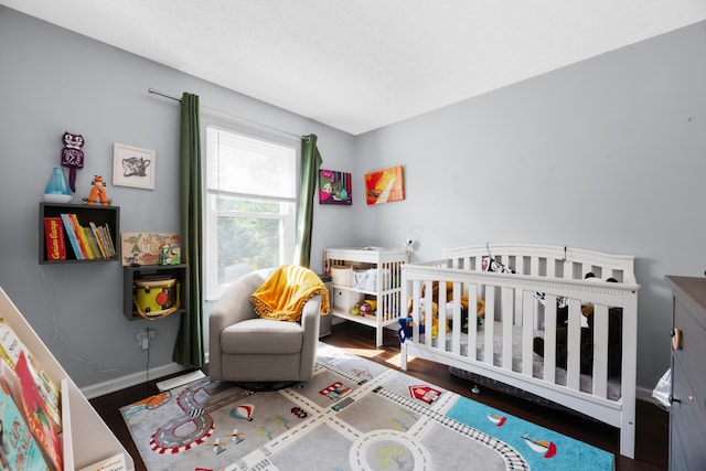3823 Ramblehurst Rd, Columbus, OH 43221 - bedroom with wood finished floors and a crib