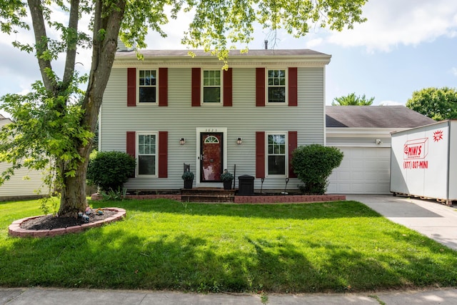 3823 Ramblehurst Rd, Columbus, OH 43221 - colonial-style house featuring an attached garage, concrete driveway, and a front lawn