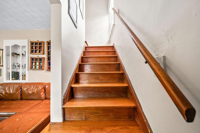 1467 Melrose Ave, Columbus, OH 43224 - stairs with wood finished floors and a textured ceiling