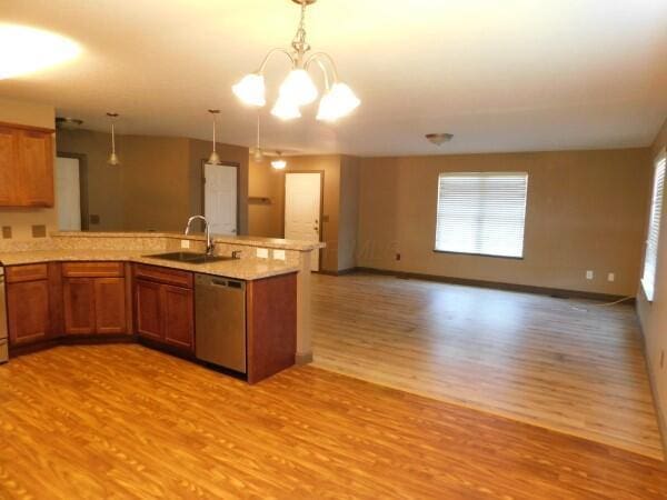 32340 Lilac Ln, Logan, OH 43138 - kitchen featuring stainless steel dishwasher, light wood-type flooring, brown cabinets, open floor plan, and a peninsula
