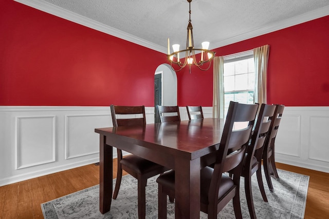 5683 Levi Kramer Blvd, Canal Winchester, OH 43110 - dining space with a chandelier, a textured ceiling, wainscoting, arched walkways, and ornamental molding