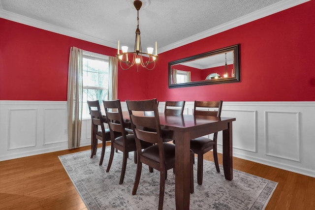 5683 Levi Kramer Blvd, Canal Winchester, OH 43110 - dining space with a chandelier, wainscoting, a textured ceiling, ornamental molding, and wood finished floors