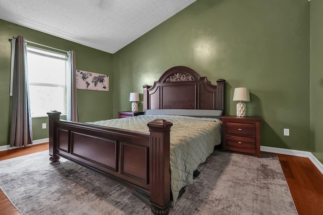 5683 Levi Kramer Blvd, Canal Winchester, OH 43110 - bedroom featuring wood finished floors, vaulted ceiling, and a textured ceiling