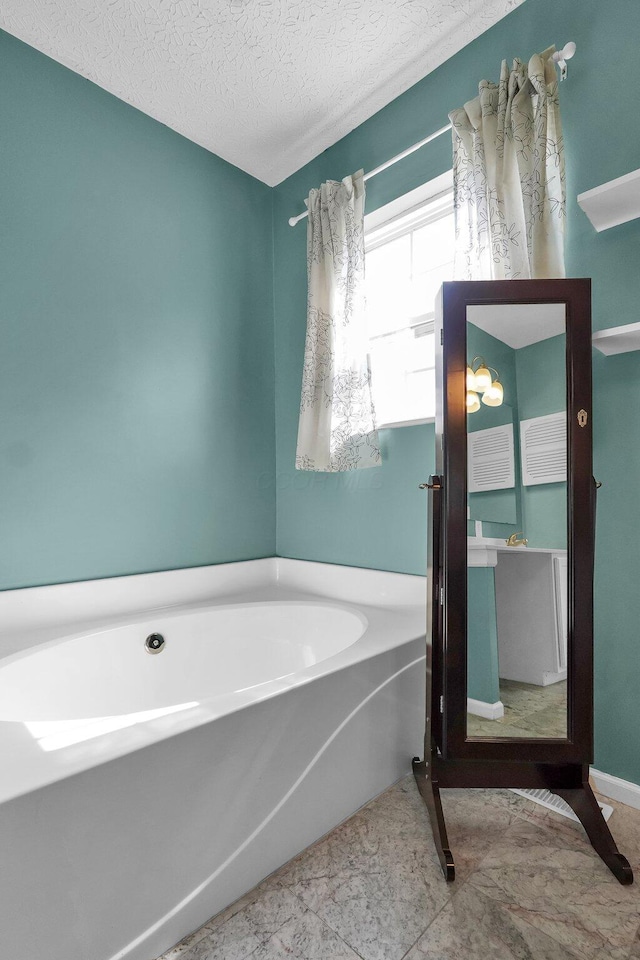 5683 Levi Kramer Blvd, Canal Winchester, OH 43110 - bathroom featuring a bath and a textured ceiling
