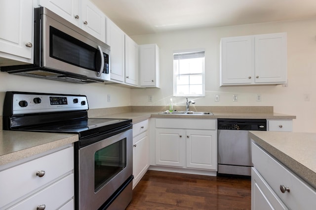 7145 Billy Goat Dr, New Albany, OH 43054 - kitchen featuring appliances with stainless steel finishes, white cabinetry, dark wood-style floors, and light countertops