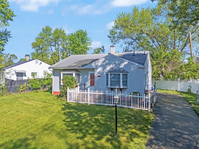 2272 Eden Ave, Columbus, OH 43224 - bungalow-style home featuring a chimney, a fenced backyard, a shingled roof, and driveway