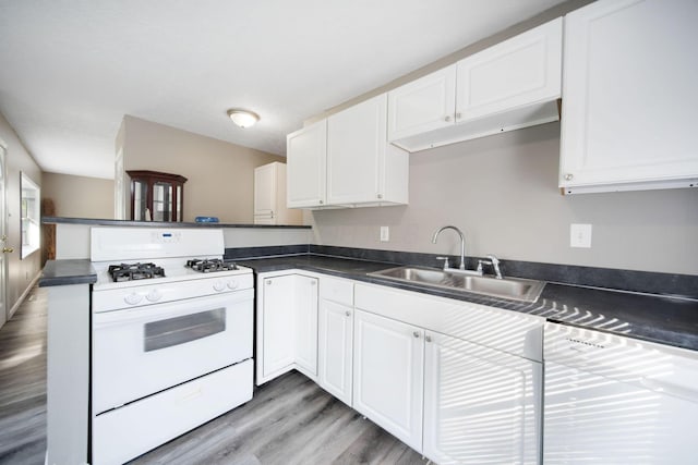 2272 Eden Ave, Columbus, OH 43224 - kitchen featuring white gas stove, a peninsula, white cabinetry, light wood-style flooring, and dark countertops