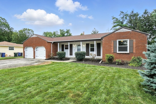 899 Meadowview Dr, Columbus, OH 43224 - single story home with covered porch, an attached garage, brick siding, driveway, and a front yard