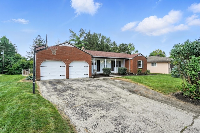899 Meadowview Dr, Columbus, OH 43224 - single story home with brick siding, driveway, a garage, a front yard, and covered porch