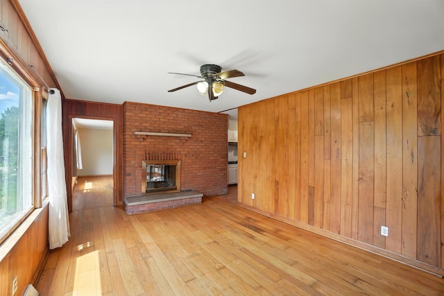 899 Meadowview Dr, Columbus, OH 43224 - unfurnished living room with wooden walls, ceiling fan, plenty of natural light, and hardwood / wood-style flooring