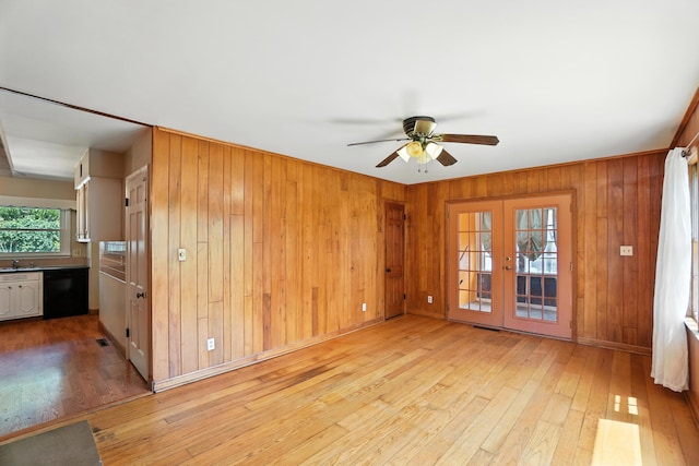 899 Meadowview Dr, Columbus, OH 43224 - unfurnished room with light wood finished floors, a ceiling fan, and wood walls