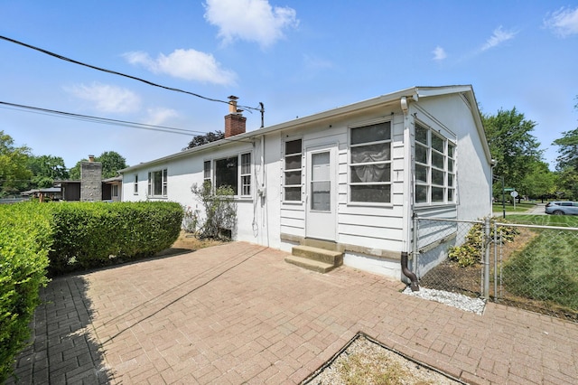 899 Meadowview Dr, Columbus, OH 43224 - ranch-style house with entry steps, a chimney, and a patio area