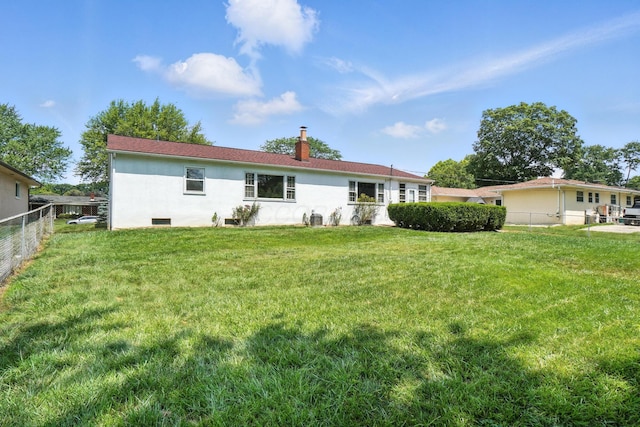 899 Meadowview Dr, Columbus, OH 43224 - rear view of house featuring a chimney and stucco siding