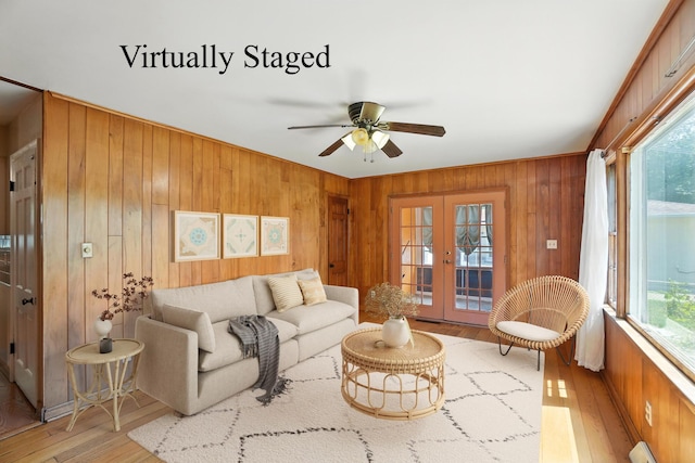 899 Meadowview Dr, Columbus, OH 43224 - living room with wood walls, wood-type flooring, french doors, ceiling fan, and baseboard heating