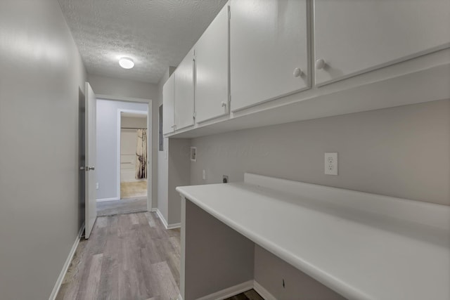 6658 Lagrange Dr Unit 43E, Canal Winchester, OH 43110 - laundry area with cabinet space, a textured ceiling, electric dryer hookup, light wood-type flooring, and hookup for a washing machine