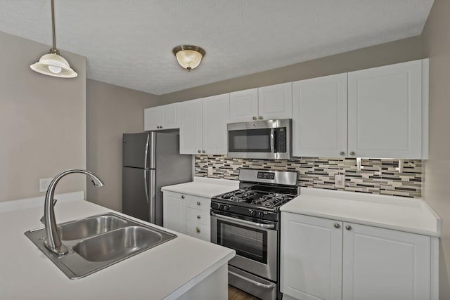 6658 Lagrange Dr Unit 43E, Canal Winchester, OH 43110 - kitchen with stainless steel appliances, white cabinets, decorative backsplash, light countertops, and a textured ceiling