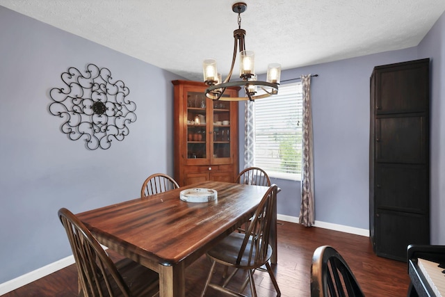 664 Dukewell Pl, Galloway, OH 43119 - dining room featuring a chandelier, dark wood-type flooring, and a textured ceiling