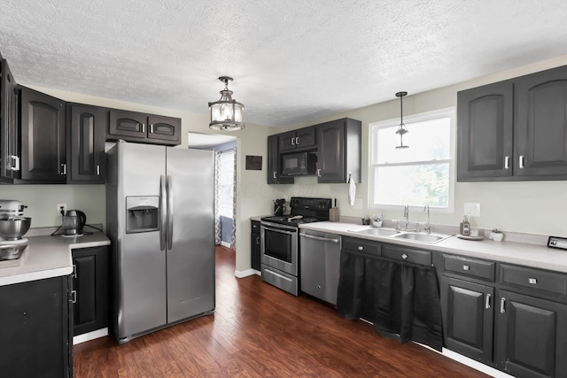 664 Dukewell Pl, Galloway, OH 43119 - kitchen featuring stainless steel appliances, plenty of natural light, a textured ceiling, dark wood finished floors, and light countertops