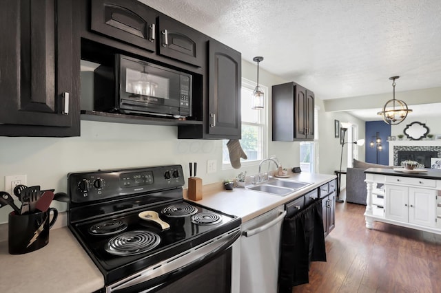 664 Dukewell Pl, Galloway, OH 43119 - kitchen featuring range with electric cooktop, stainless steel dishwasher, black microwave, dark wood-style floors, and a textured ceiling