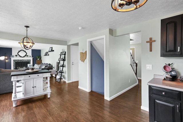 664 Dukewell Pl, Galloway, OH 43119 - kitchen with a chandelier, open floor plan, a textured ceiling, dark wood-style floors, and hanging light fixtures
