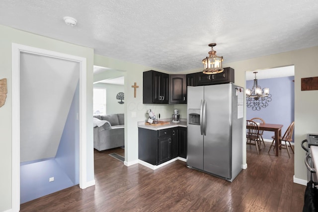 664 Dukewell Pl, Galloway, OH 43119 - kitchen featuring stainless steel fridge, a chandelier, dark wood-style flooring, light countertops, and a textured ceiling
