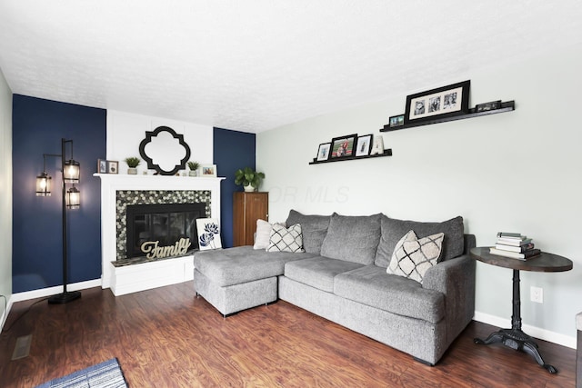 664 Dukewell Pl, Galloway, OH 43119 - living room featuring a fireplace, wood finished floors, and a textured ceiling