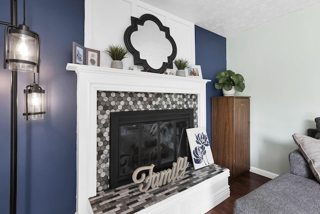 664 Dukewell Pl, Galloway, OH 43119 - detailed view of wood finished floors, a tile fireplace, and a textured ceiling