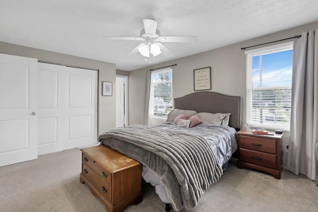 664 Dukewell Pl, Galloway, OH 43119 - bedroom featuring light colored carpet, ceiling fan, and a closet