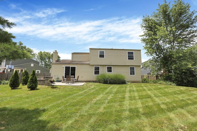 664 Dukewell Pl, Galloway, OH 43119 - rear view of house with a chimney and a patio area