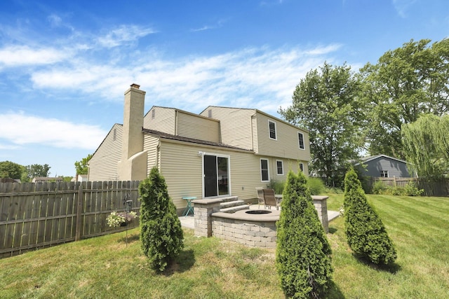 664 Dukewell Pl, Galloway, OH 43119 - rear view of property featuring an outdoor fire pit, a chimney, and a patio area