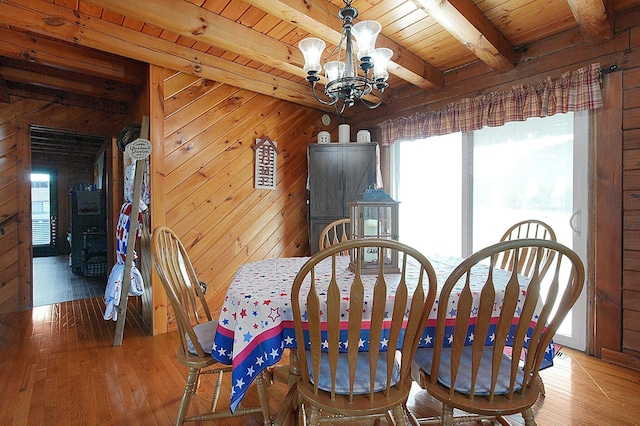 8713 State Route 207, Mount Sterling, OH 43143 - dining space featuring a chandelier, plenty of natural light, light wood-style floors, a wooden ceiling with exposed beams, and wood walls