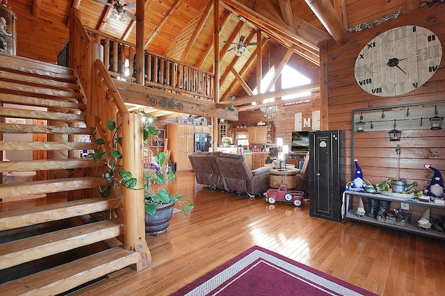 8713 State Route 207, Mount Sterling, OH 43143 - living area with wooden walls, hardwood / wood-style floors, high vaulted ceiling, stairs, and ceiling fan