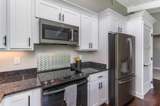 2109 W 5th Ave Unit C, Grandview Heights, OH 43212 - kitchen with stainless steel appliances, white cabinetry, dark stone counters, and dark wood-type flooring