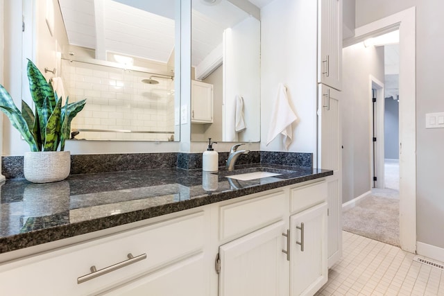 2109 W 5th Ave Unit C, Grandview Heights, OH 43212 - kitchen featuring white cabinets, light tile patterned floors, dark stone countertops, and light colored carpet